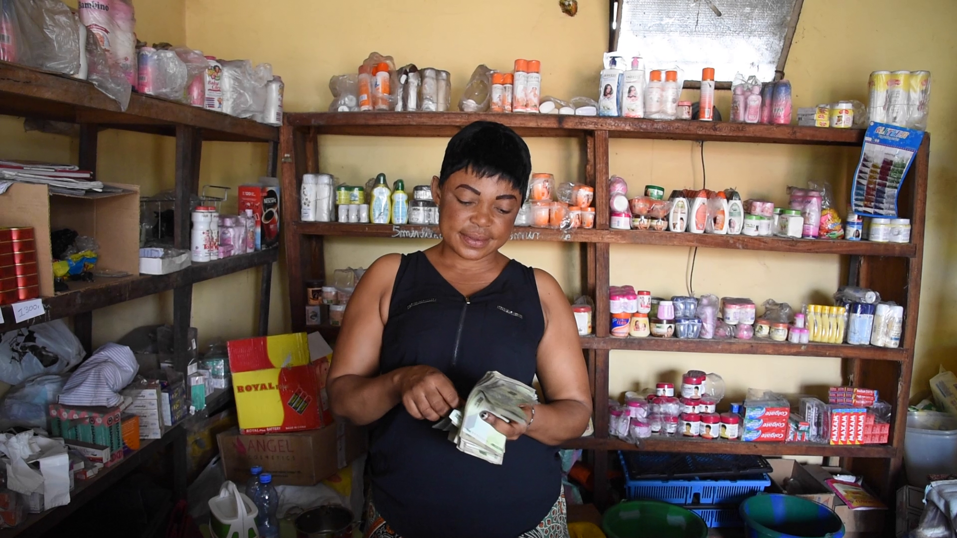 Innocente counting money in her shop