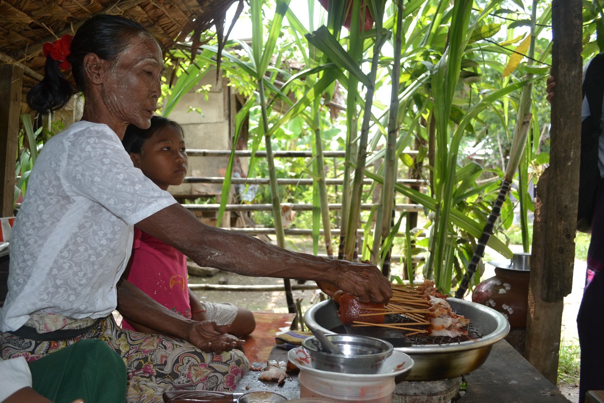 Daw Daw preparing food items she sells to make income