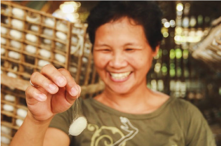 Arlene holding a cocoon which is one of the 100 kilos she harvests