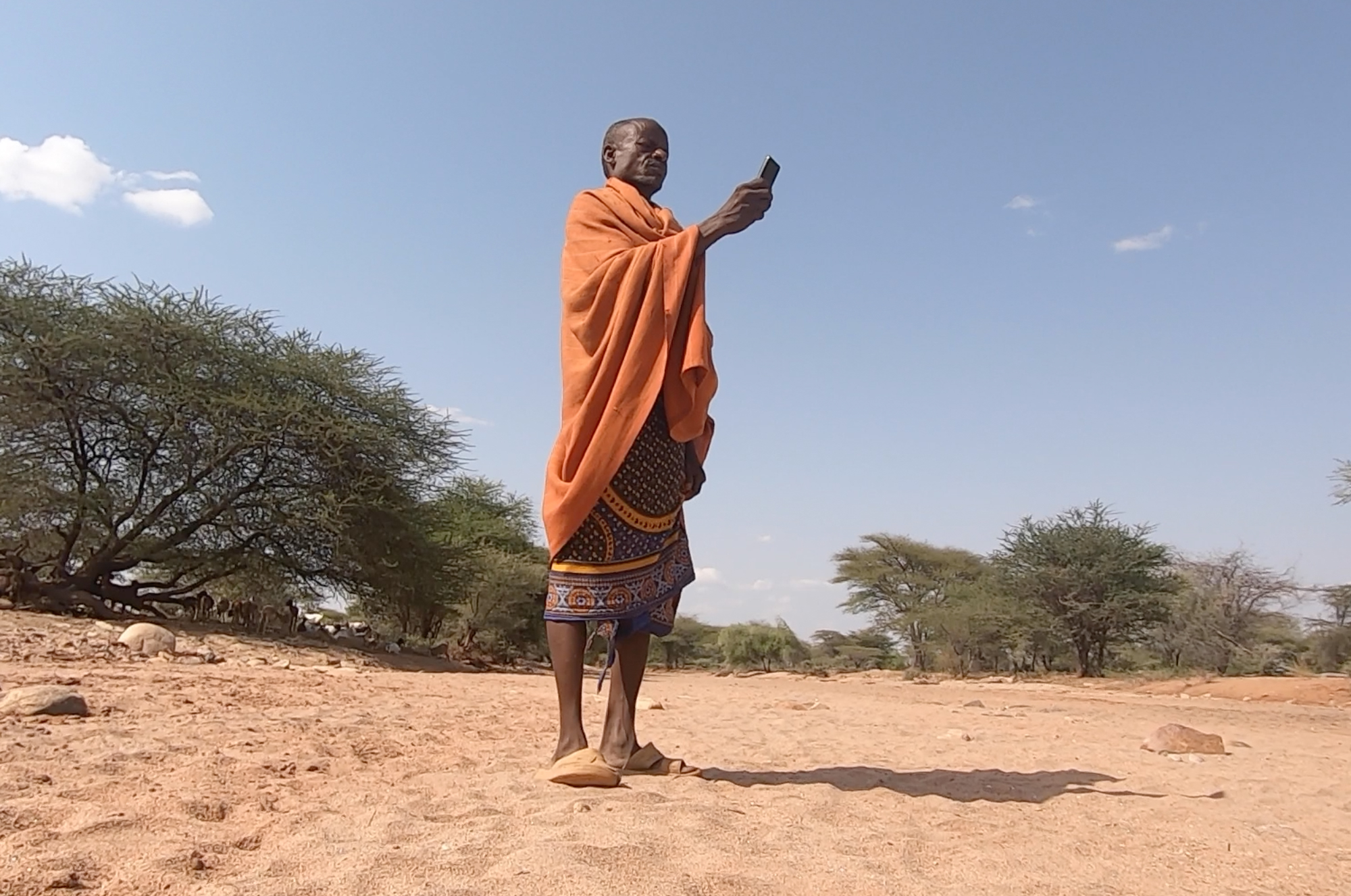 Man holding cell phone in Kenya