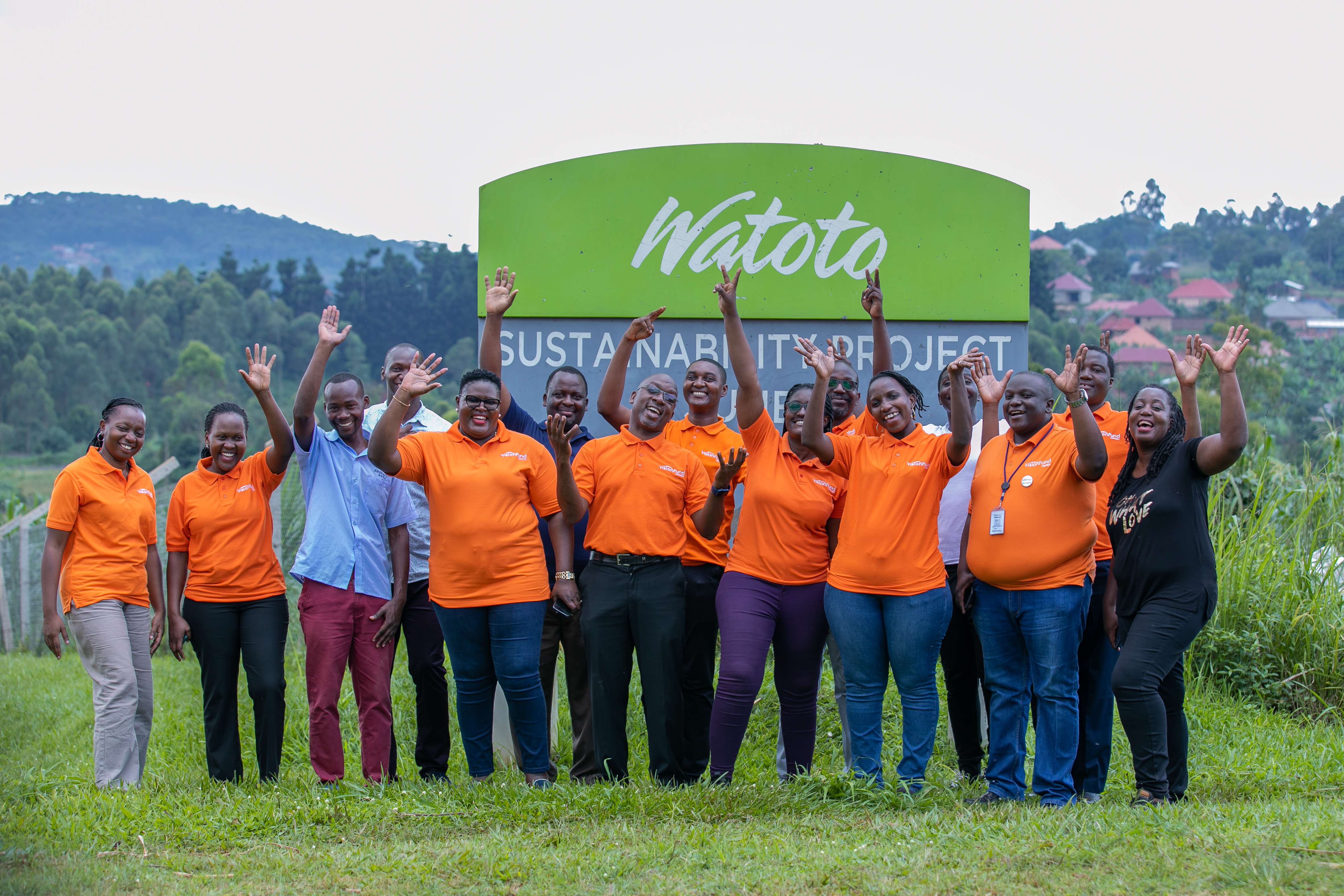 VisionFund Uganda staff pose at a Watoto Sustainability Project site