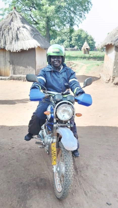 Annet on her motorbike ready to travel to the field for credit operations