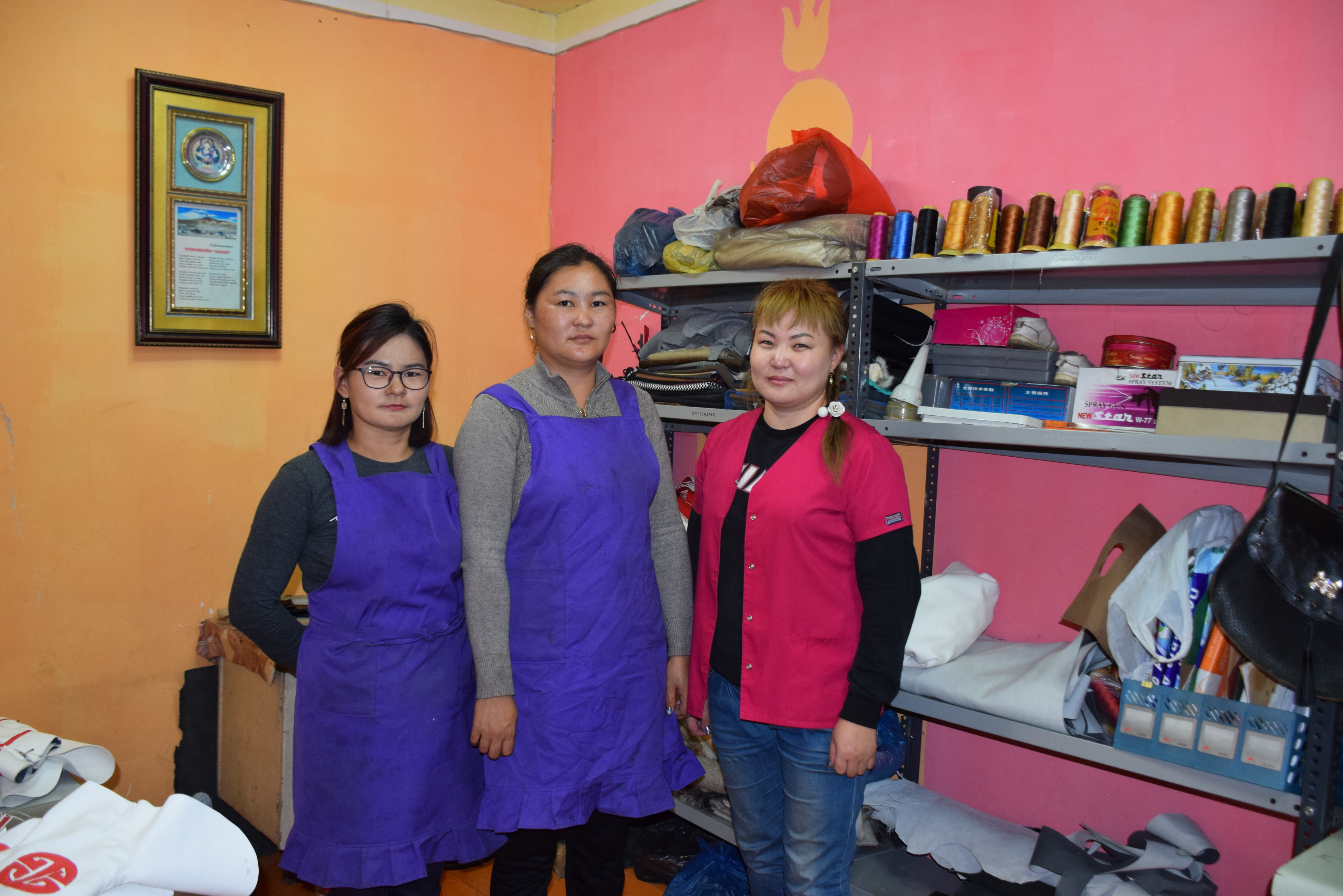 Erdenebayar and two of her six employees that work for her boot manufacturing company. 