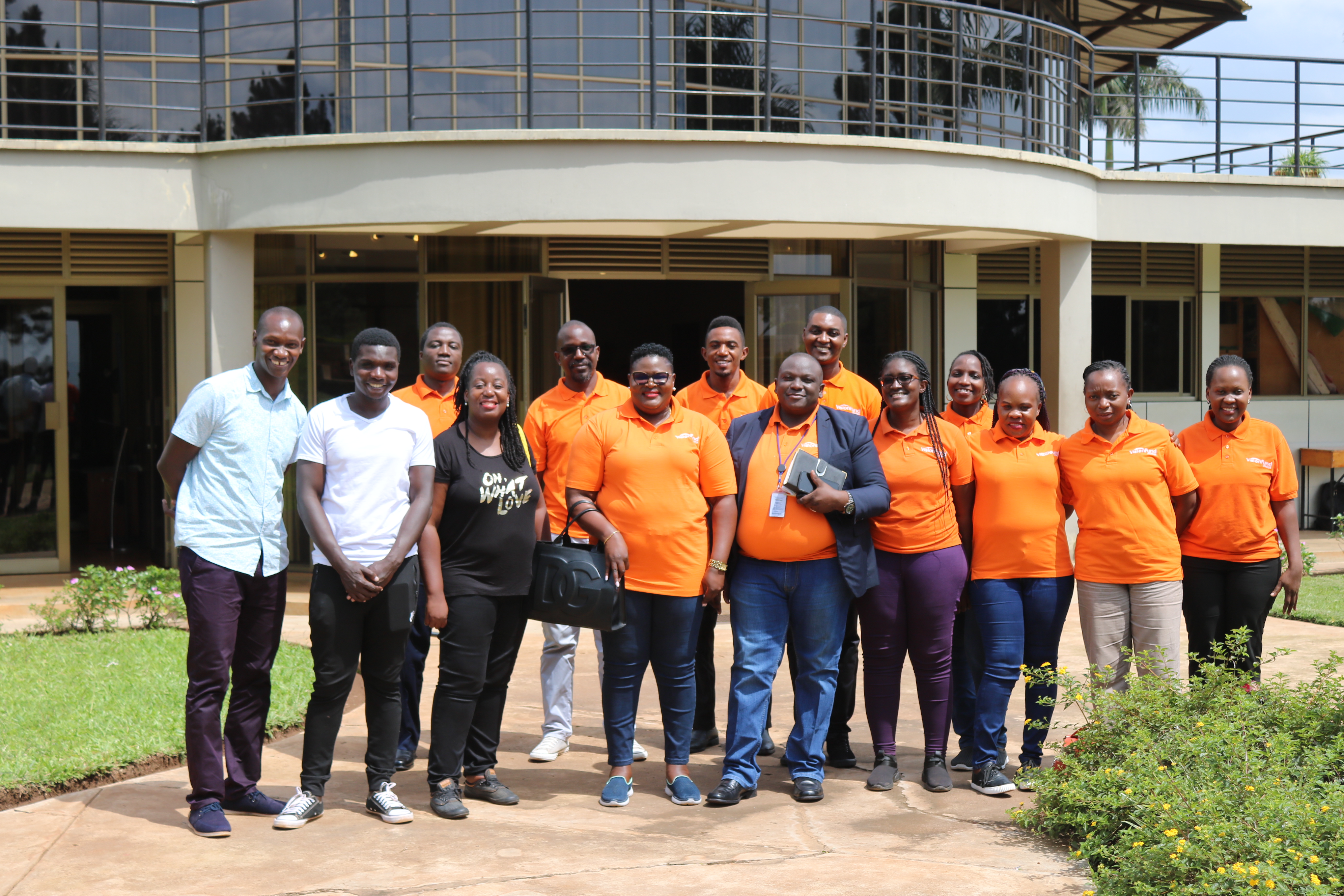 Watoto leadership and VisionFund Uganda staff pose for photo