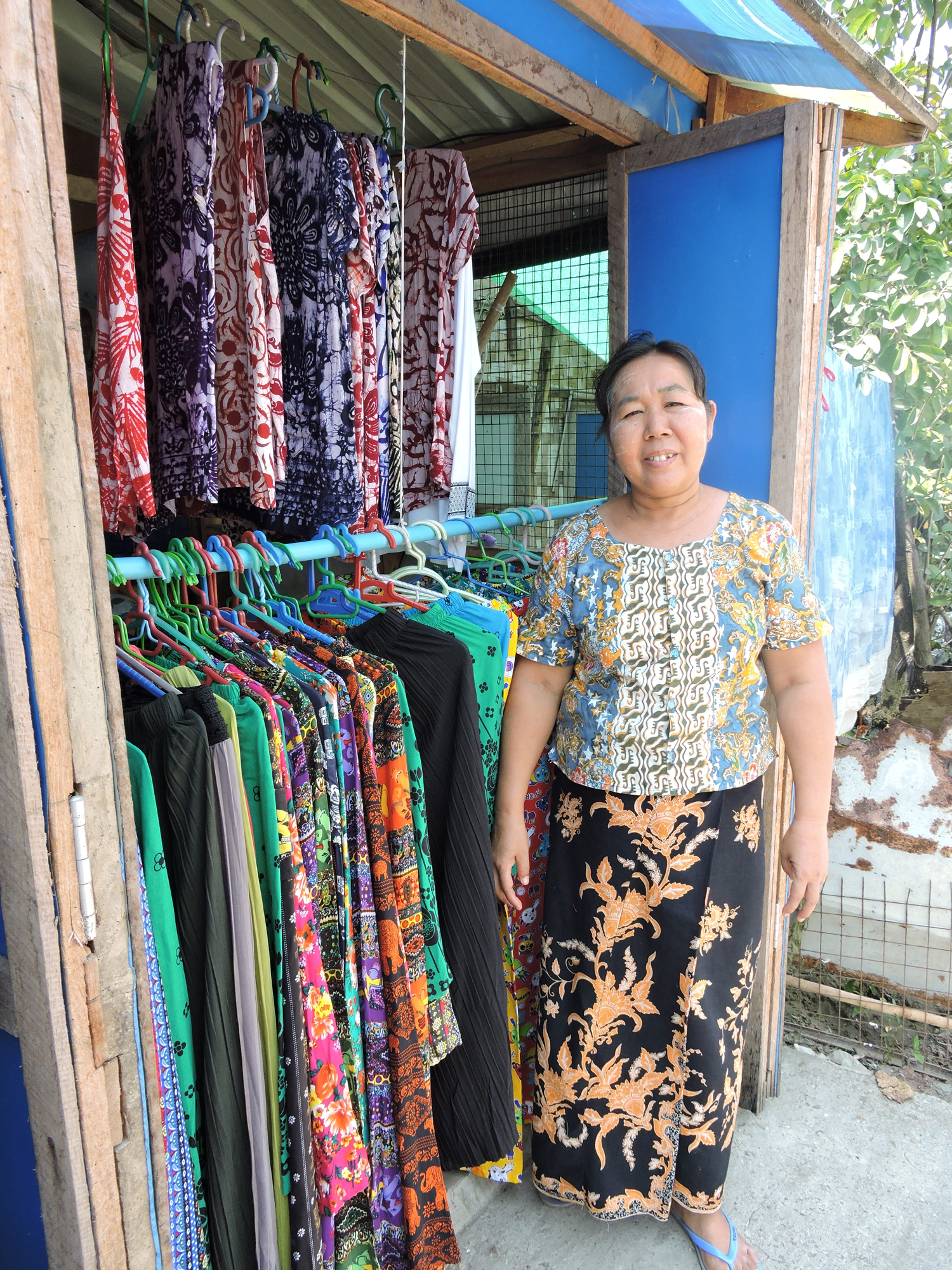 Woman standing in front of her shop