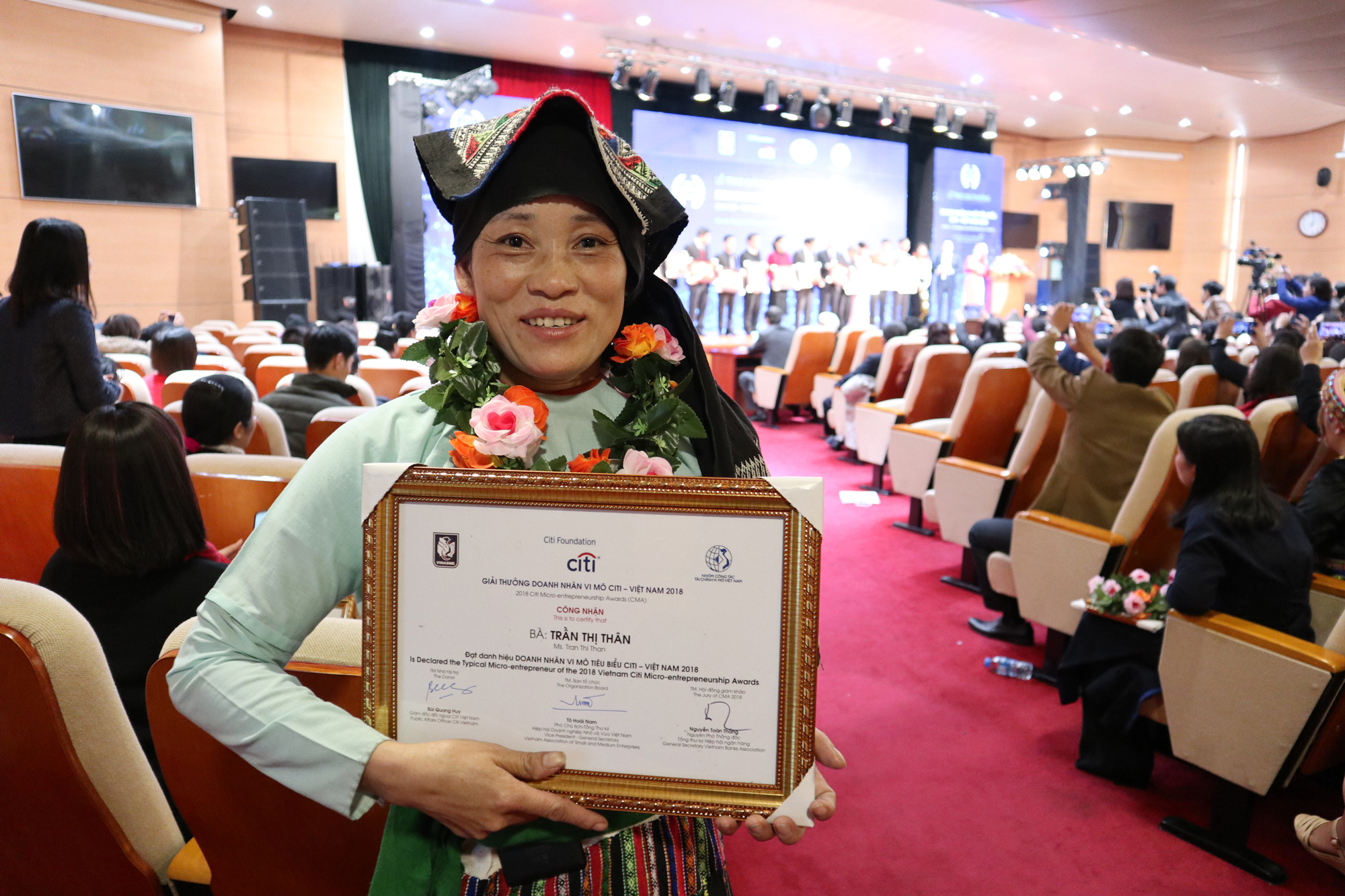 Tran with her Citi Vietnam Foundation Award for one of 30 Typical Micro-Entrepreneur award. 