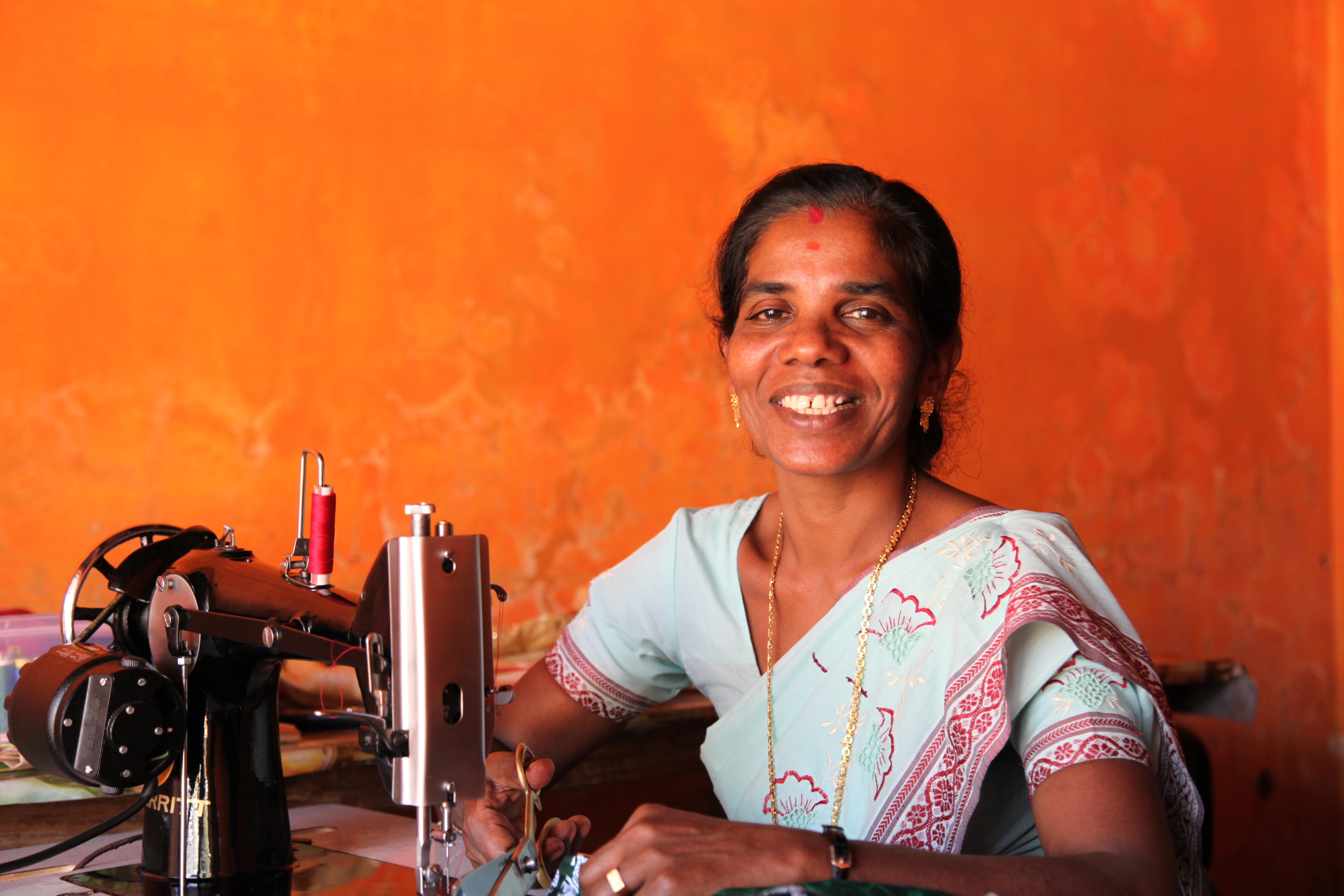 Sujata at her sewing machine in India