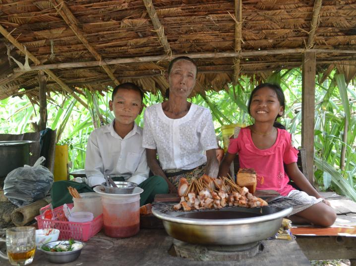 Daw San with her two grandchildren in their home in Myanmar