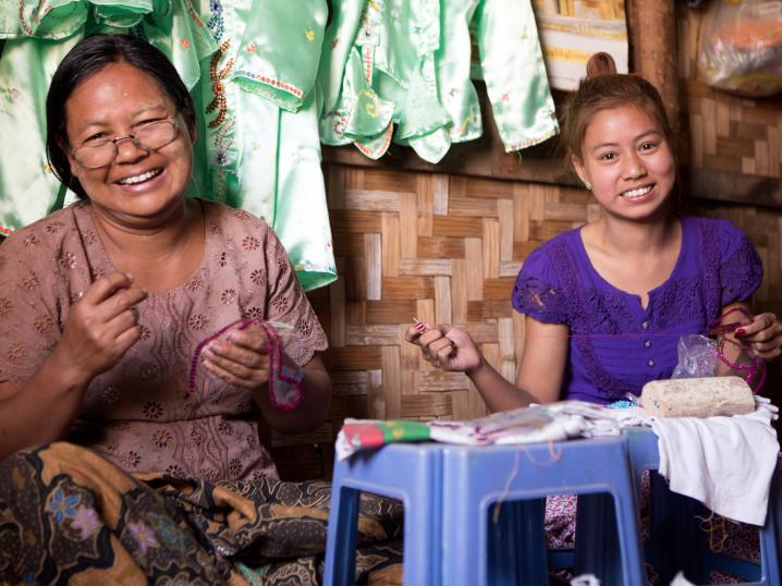 Myint Myint and her daughter working at their seamstress store.