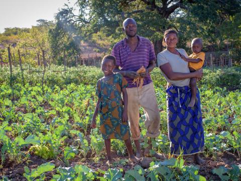 Family standing in farm in Zambia
