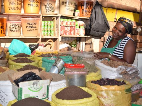 Pheona with her spice business at the Uganda marketplace