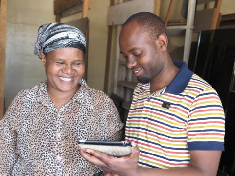 VisionFund loan officer collecting client data via tablet