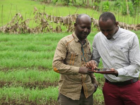 VisionFund loan officer collecting client data via tablet in Tanzania