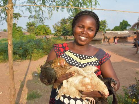 Women from DR Congo holding chickens
