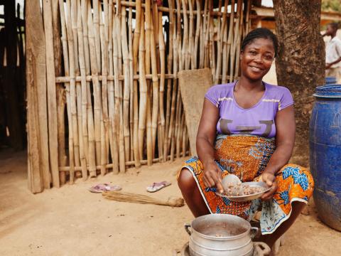 Woman in Ghana cooking beans
