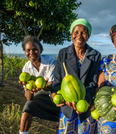 Group of women holding produce from their farm in Kenya