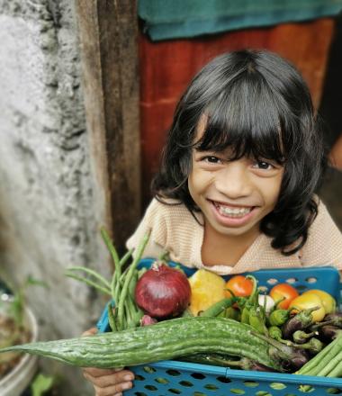 Child holdings vegetables