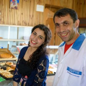 Husband and wife in bustling bakery in Armenia