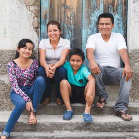 Family of four sitting on stairs in Dominican Republic