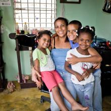 Mother with three children in her salon in Dominican Republic