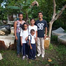 Family of six standing in front of home in Dominican Republic