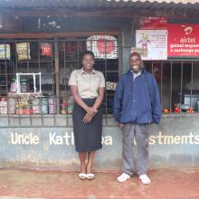 Feston and his VisionFund Malawi loan officer in front of his store. 
